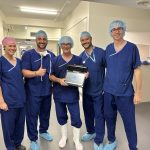 During surgery, Timothy Schneider, MBBS, FRACS, operates with GPS Ankle, then captures the moment afterward with the O.R. team.