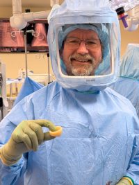 Dr. Thomas Wright holds the new humeral liner during surgery.